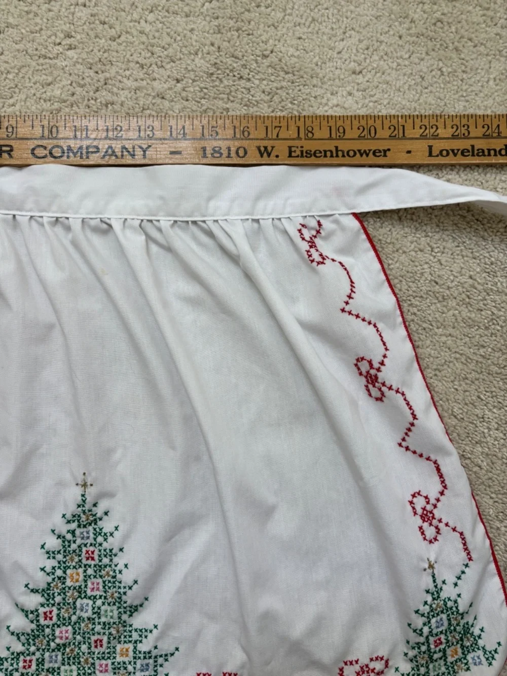 Vintage white half apron featuring hand-stitched cross-stitch Christmas trees